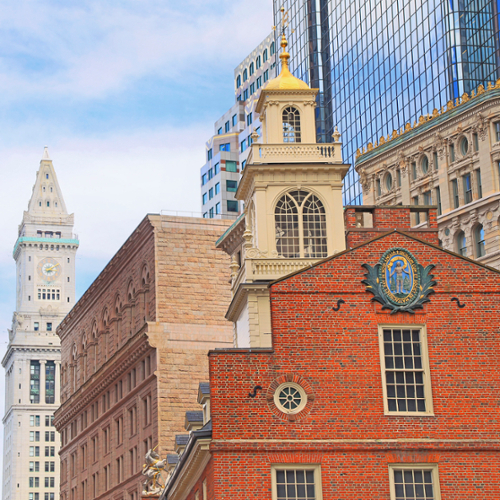 A shot of the Old State House in downtown Boston, with the Custom Tower rising behind it.