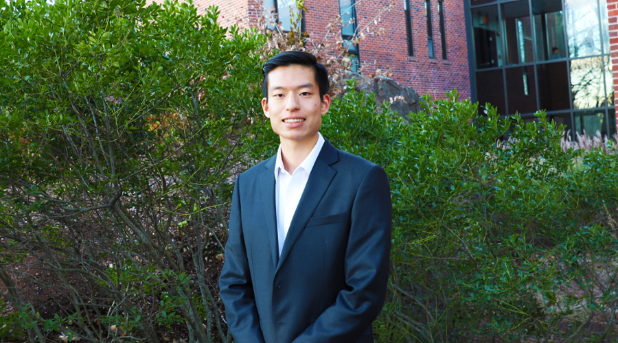 A portrait of Brian Hseih in a blue jacket and white shirt.