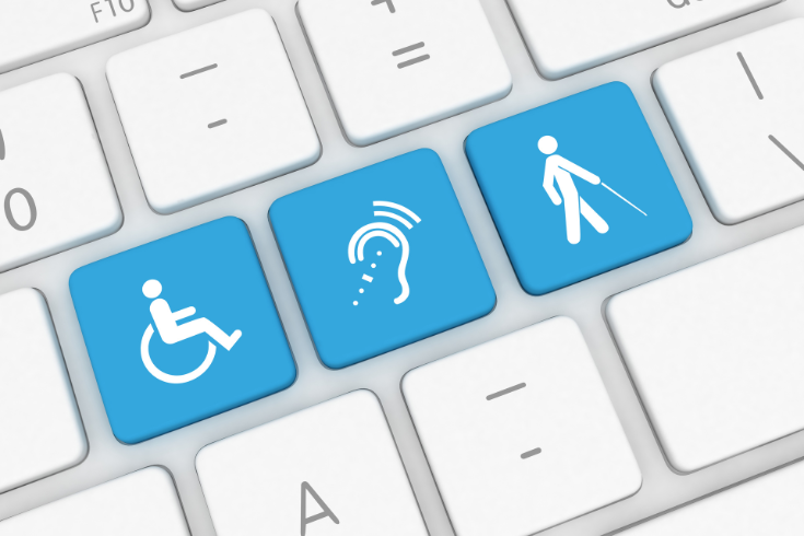 Laptop keyboard with three blue keys. The first key has an image of a person in a wheelchair, the second has an image of an ear, the third has an image of a person walking with a cane.