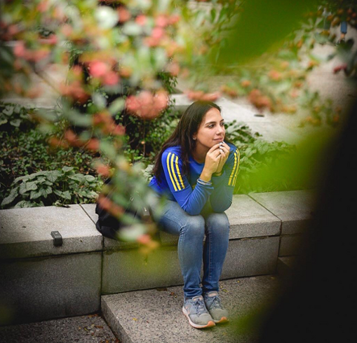 Adriana Dianderas sitting in a garden.
