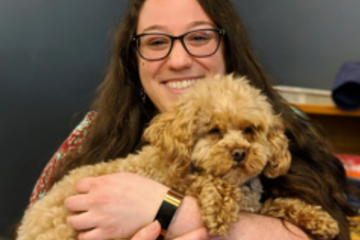 Esther Brandon holding a fluffy dog.