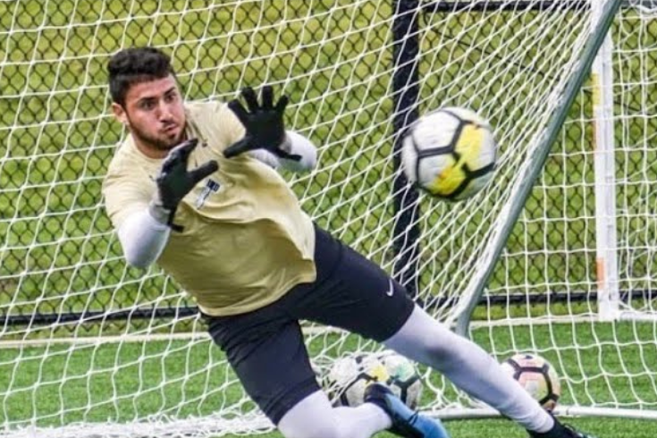 Gregory Irwin mid-save as a goalie for the Brandeis Judges