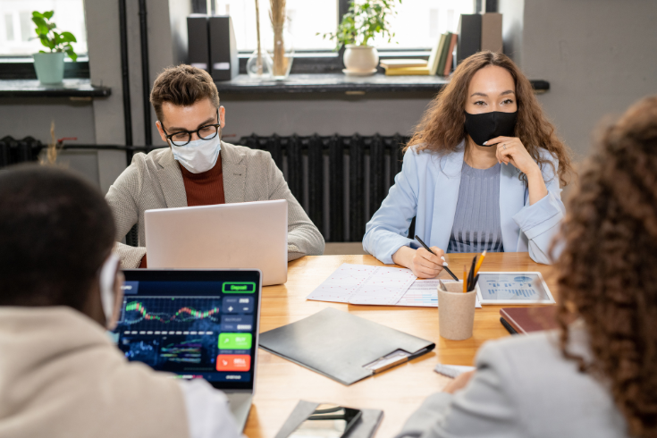 Healthcare professionals sitting at a conference table.