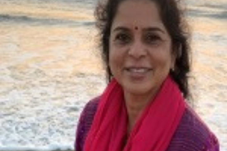 Jeyanthi Ghatraju standing on a beach.