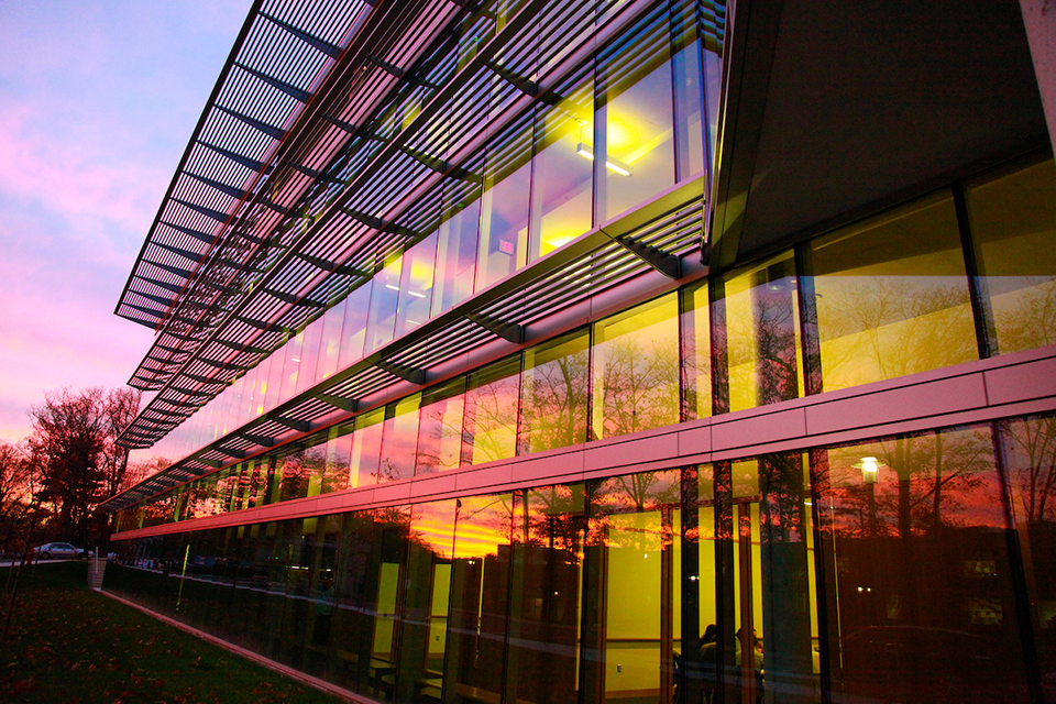 a glass building in the sunset