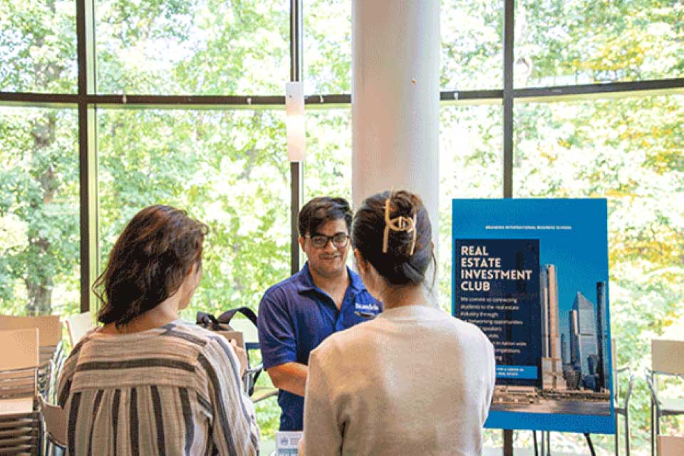 three student at the club fair