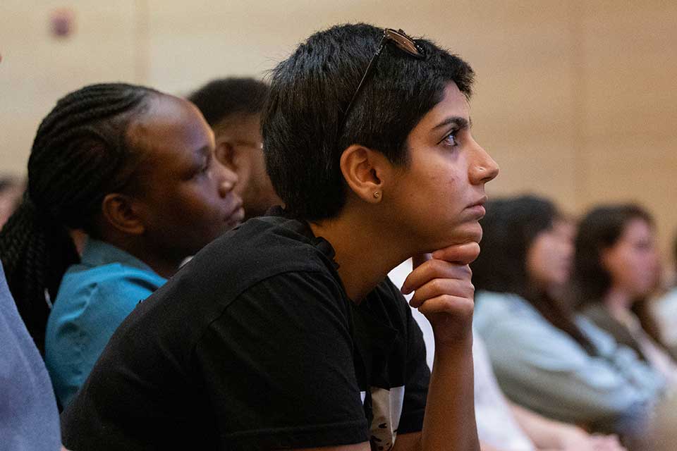 Students listening to a presentation during graduate student orientation