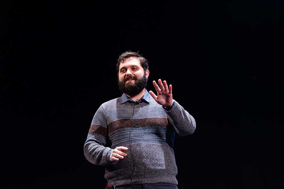 Mike Vivian, holding up a hand, presents.