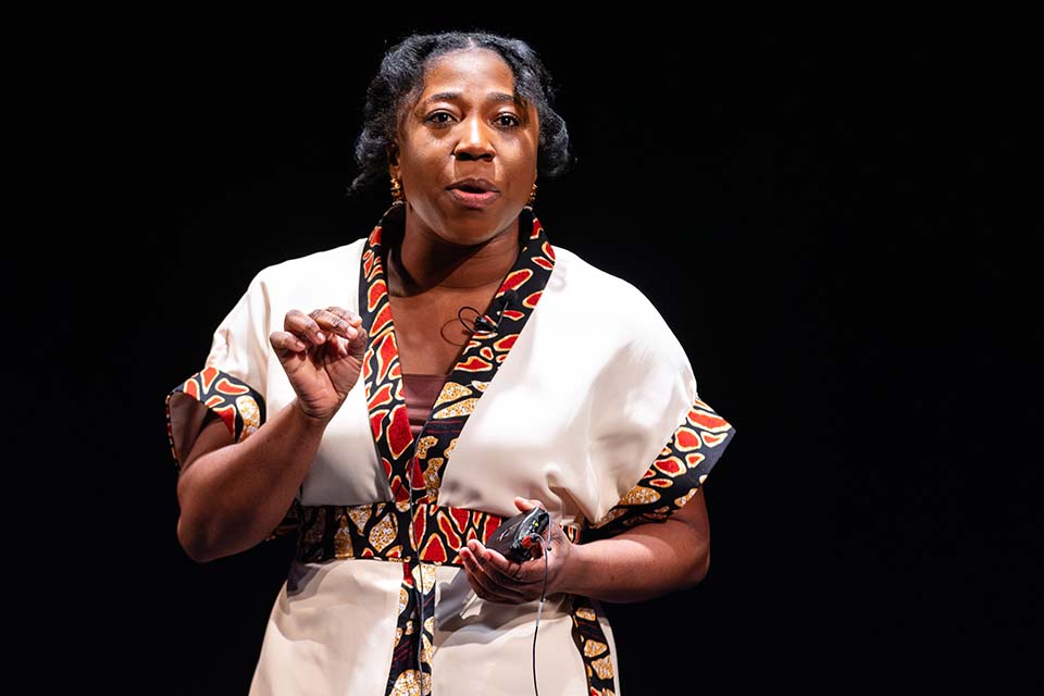 Ophelia Delali Akoto stands speaking.