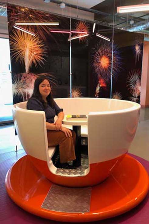Deanna Daly sits in a giant teacup.