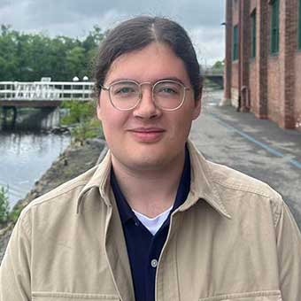 Maxwell Pickering stands near the Charles River
