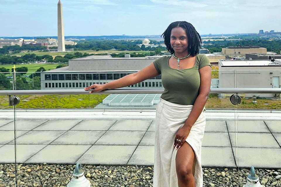 Onyx Allen stands outside with a view of the Washington Monument in the background.