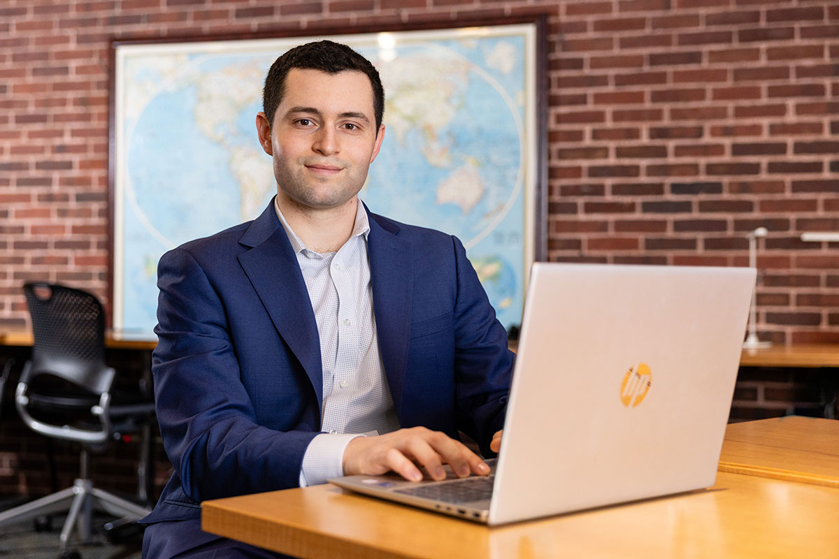 Benjamin Schwartz sits at a laptop.