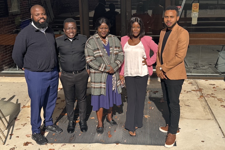 Chukwuemeka A. Agbarakwe, Ratherfold Njanji, Lydia Randall, Charmaine Phiri, and Richmond Dzeamesi stand in a line outside a building.
