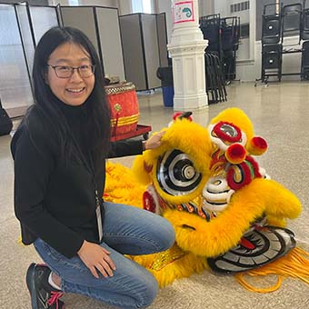 Yuxiao Long poses with a Chinese dragon.