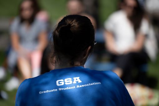 A student, seen from behind, wears a shirt that says GSA on the back.