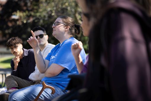 Students sit in a circle.