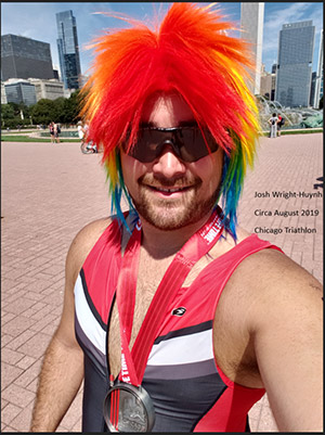 Josh Wright-Huyn wearing multicolored wig and sunglasses