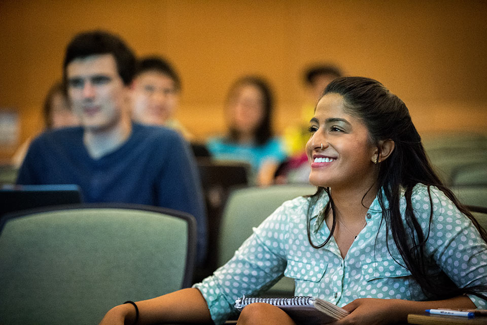 Students seated in a classroom listen to a lecture