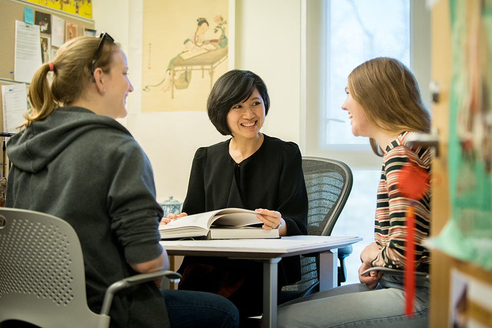 Professor Aida Wong meeting with two students in her office