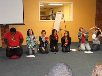 students in a room kneeling