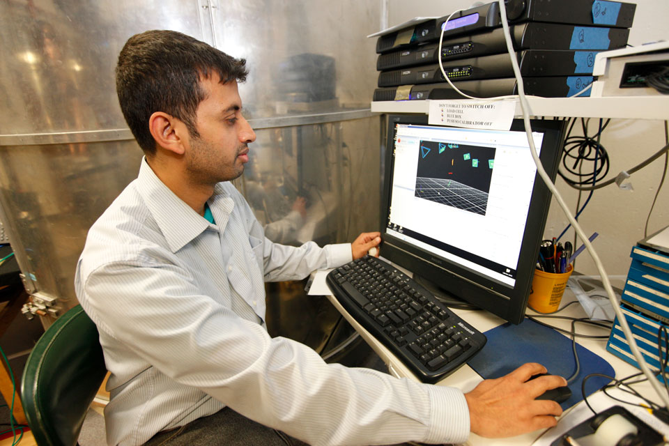 A researcher works with someone participating in a study