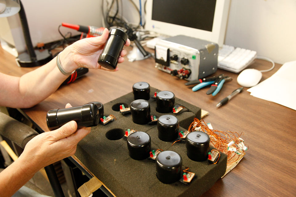 A person holds the equipment needed for weight discrimination research