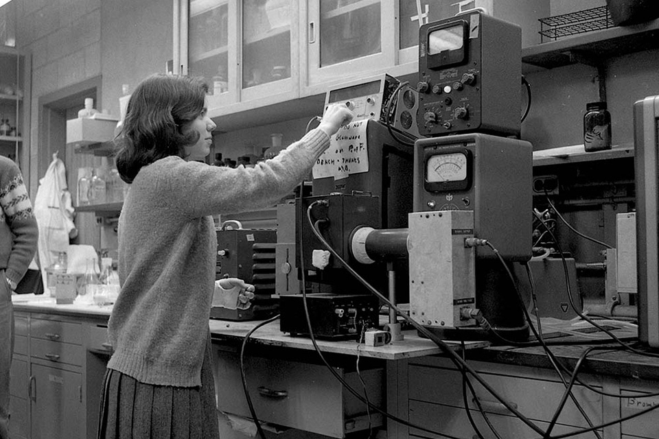 Female student working with machines in a lab