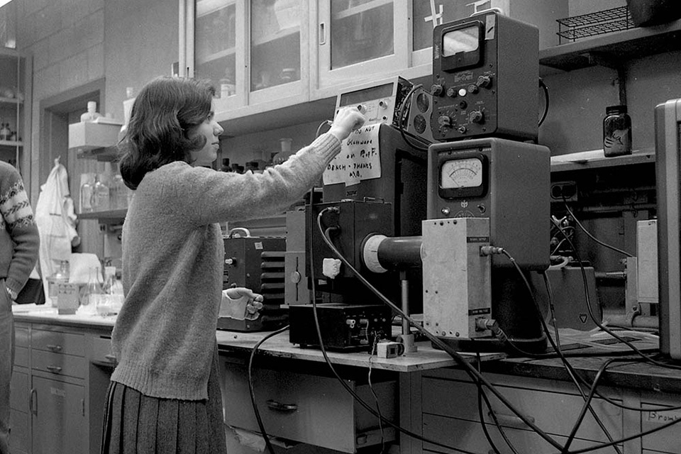 Female student working with machines in a lab