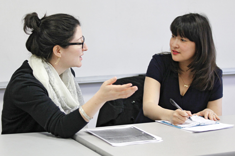A faculty member speaking with one student