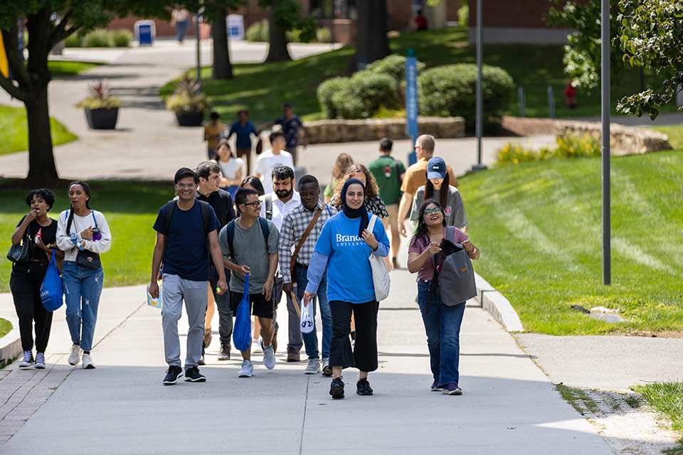 Graduate students walking through the Brandeis campus