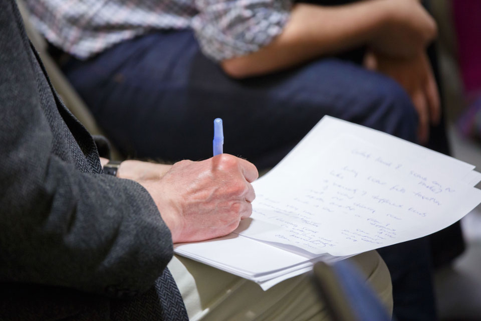 A hand writes on paper.