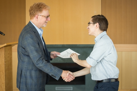 eric chasalow gives a certificate to a student