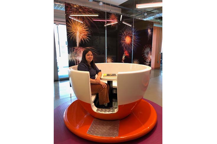 Deanna Daly sits in a giant teacup.