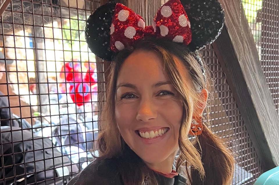 Haley Talbert smiles while wearing Minnie Mouse ears.