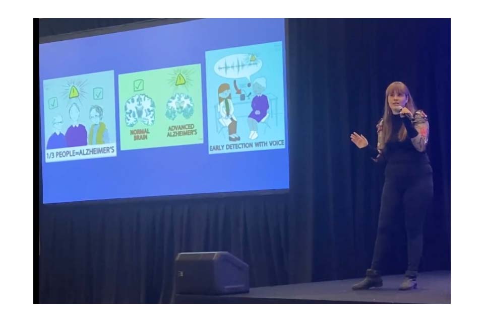 Liz Mahon presents in front of a slide.