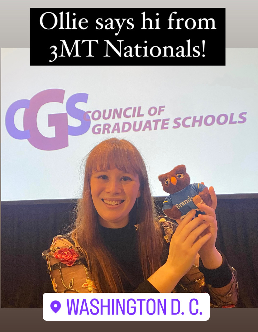 Liz Mahon holds up Ollie the owl (a stuffed toy) in front of a Council of Graduate Schools Sign. Text reads, "Ollie says hi from 3MT Nationals! Washington, D.C." 