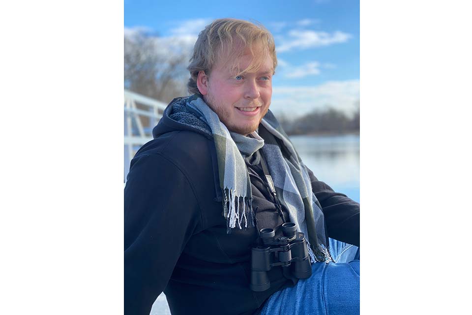 Will Dahl sits by a river.