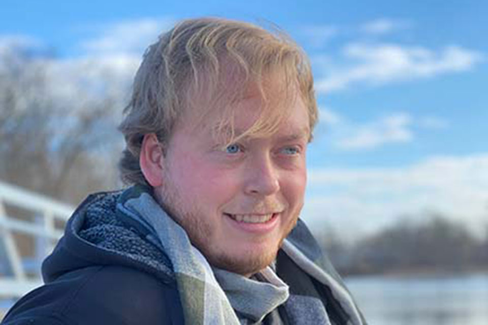 Will Dahl sits by a river.