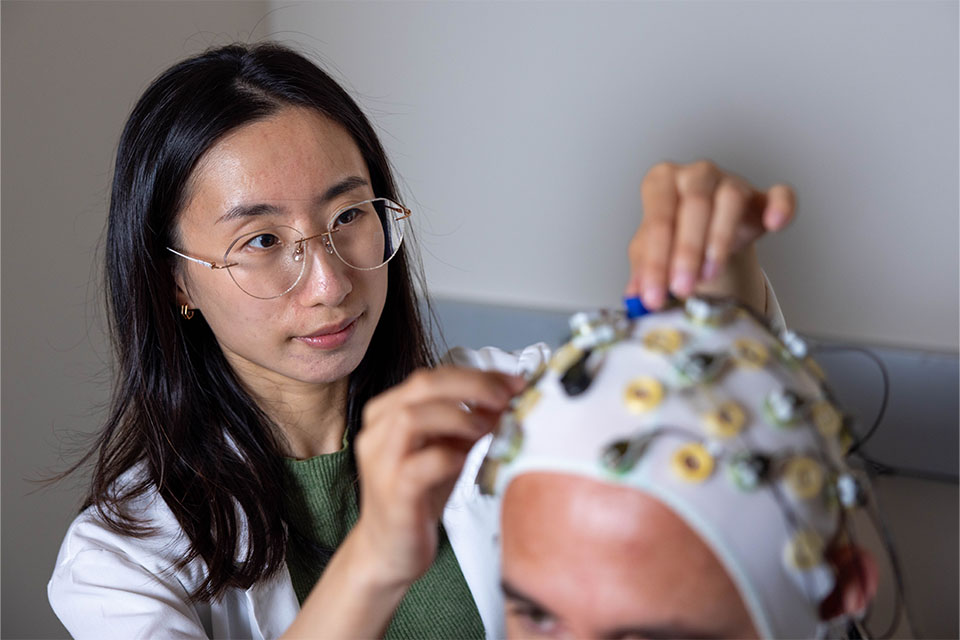 Graduate student Tong Lin working in a Psychology lab at Brandeis University