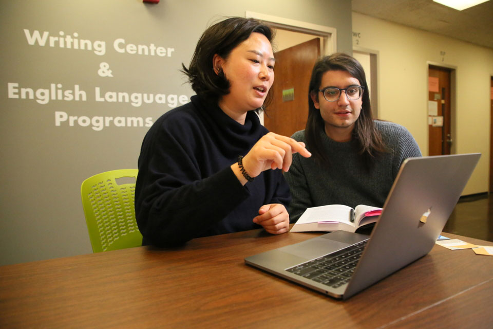 student and teacher in writing center