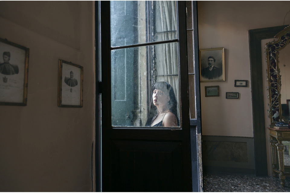 woman wearing nightgown gazing through door