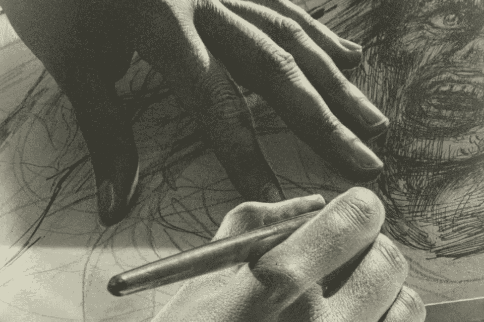 a hand drawing a picture of a wild-looking man 