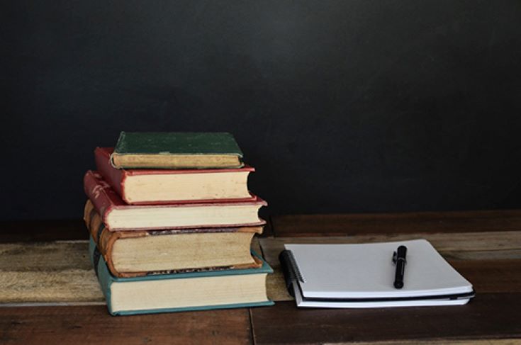 stack of books and a notebook