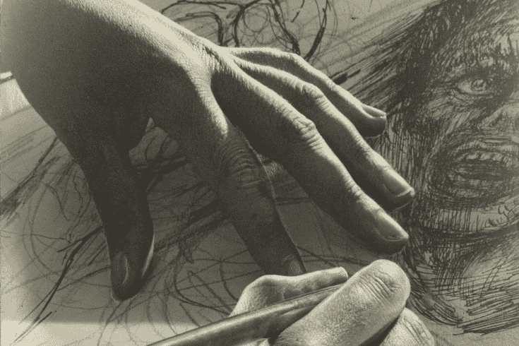 Two hands on a piece of paper, a pen in one hand, in the act of drawing a face of a person with an open mouth and wide eyes.