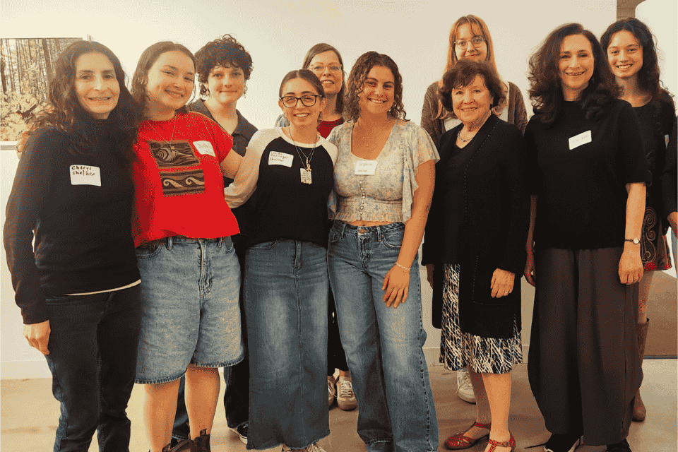 A group of people standing together smiling