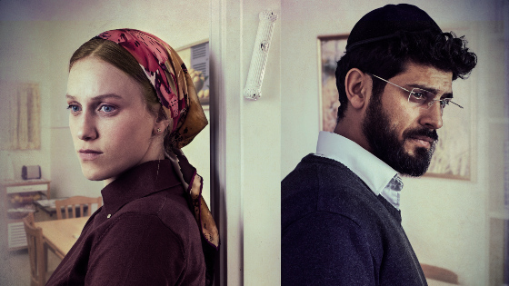 A woman and a man standing back to back with a door and a mezuzah between them