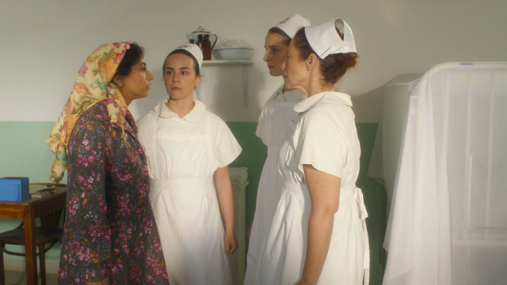 A color video still of a Yemenite mother confronting three nurses at a Baby House. 