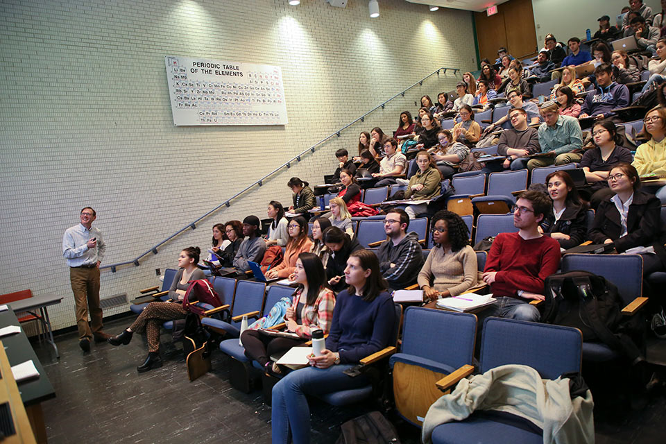 Professor James Morris lecturing in a classroom full of students