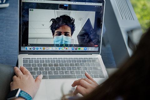 Student at a computer wearing a mask